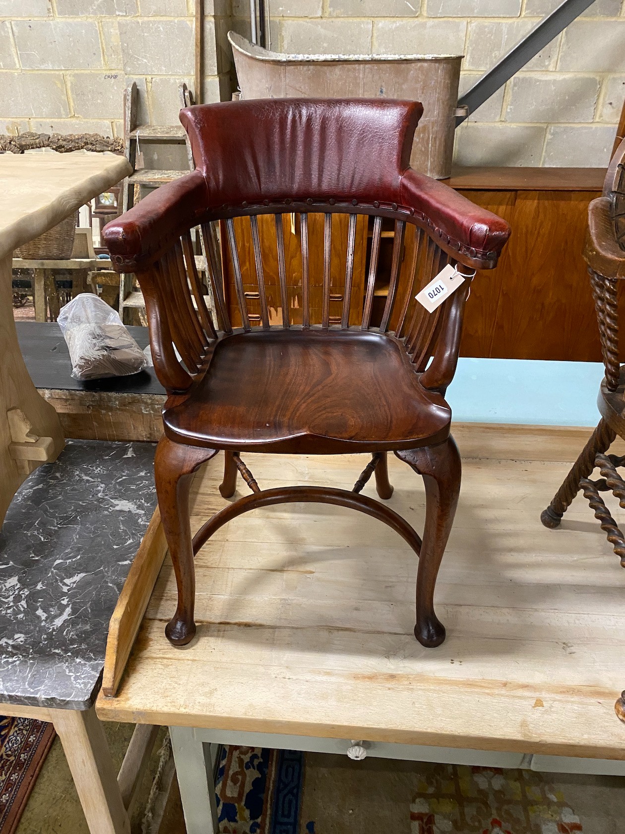 A Victorian mahogany part upholstered desk chair with saddle seat and crinoline stretcher, width 58cm, depth 45cm, height 87cm